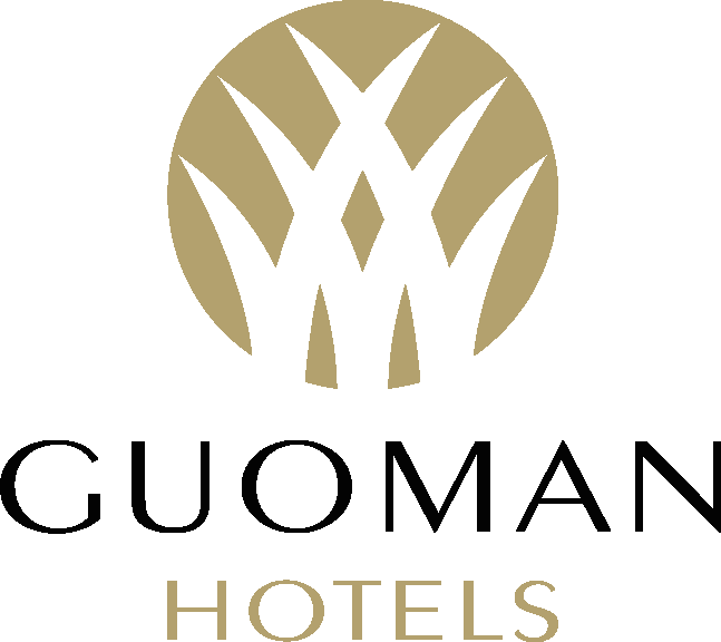 Guoman Hotels logo featuring stylized gold and white shapes above the brand name in black and gold text on a white background. Guoman Hotels is a Plasloc client.